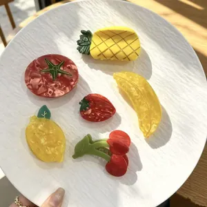 Set of colorful summer fruit-themed acetate hair claws including strawberry and pineapple