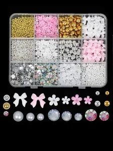 Detailed view of 12-grid mixed nail art charms with pearls, bows, and flowers
