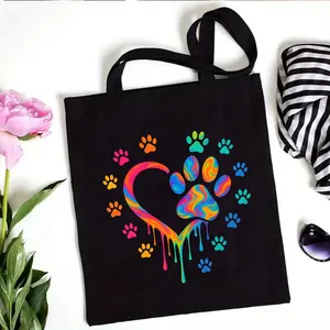 Black canvas tote bag with colorful rainbow paw print heart design for daily shopping