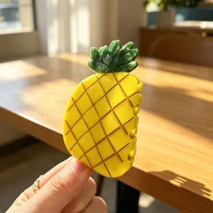 Macro detail of a yellow pineapple hair claw clip made of premium acetate material