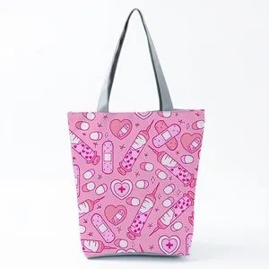 Detailed view of pink tote bag featuring cute nurse and medical themed prints