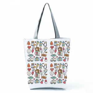 Detailed view of white canvas tote bag featuring cute cartoon nurse and medical icons print