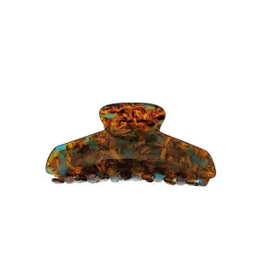 Large French tortoise shell hair claw clip for women with brown and blue marbled pattern.