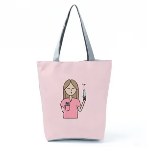 Pink tote bag with cute cartoon nurse print holding a syringe, grey handles.