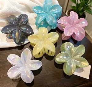 Close-up of pearlescent multi-colored flower hair claws in a variety of pastel shades