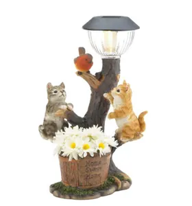 Detailed resin solar garden statue featuring two cats and bird with LED lamp and white daisies.