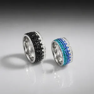 Luxury stainless steel rings featuring five-row pavé crystals in black and blue color variants