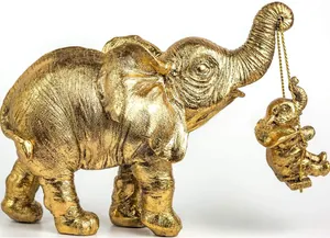 Vista dettagliata di una statuetta di elefante in resina dorata con un elefantino altalena
