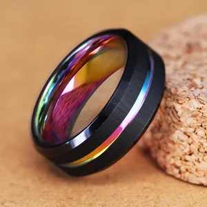 Macro detail view of a black stainless steel ring featuring a vibrant rainbow inner band