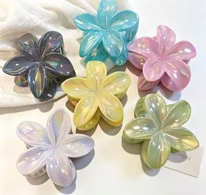 Detailed close-up view of iridescent plumeria flower hair claws in candy colors