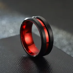 Close-up of black stainless steel ring with vibrant red interior and groove detail.