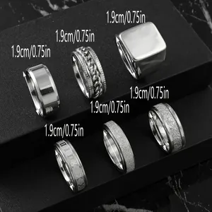 Close-up of 6 stainless steel men's rings showing various textures and 1.9cm diameter