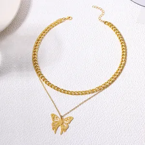 Close-up view showing the layered structure of the gold curb chain and hollow butterfly pendant