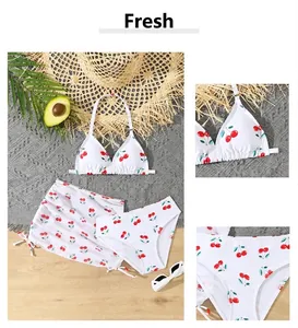 Detailed views of white 3-piece girls swimwear set featuring vibrant red cherry patterns