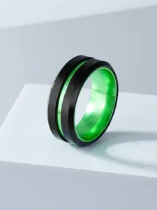 Detailed macro view of black stainless steel ring with a vibrant green inner band