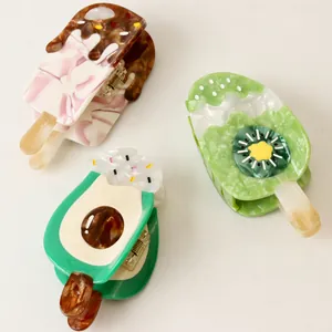 Colorful acetate hair claws with fruit and ice cream designs on a white background