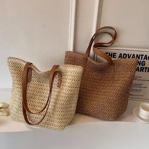 Two colors of large woven straw tote bags with faux leather straps for beach travel