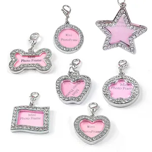 Detailed view of various shapes of rhinestone-studded pet ID tags with lobster clasps