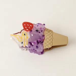 Detail shot of a creative acetate hair claw clip shaped like a fruit ice cream cone.
