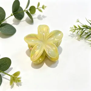 Close-up of yellow pearlescent flower hair claw clip with elegant finish