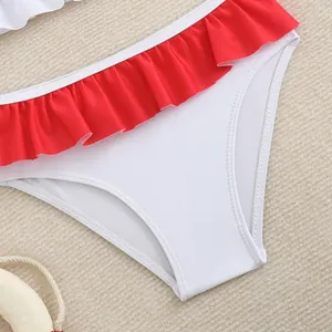Close-up of white girls' bikini bottom with red ruffled waist for beach and swimming
