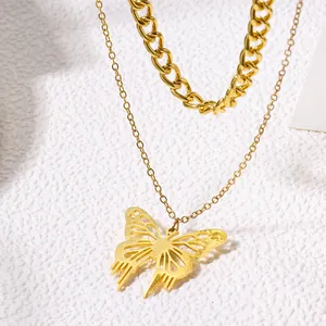 Close-up of gold hollow butterfly pendant on a stylish double-layer chain necklace.