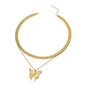 Close-up of double-layered gold necklace with hollow butterfly pendant and thick chain.