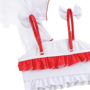 Cute girls ruffled swimsuit top in white and red with bow details and adjustable straps