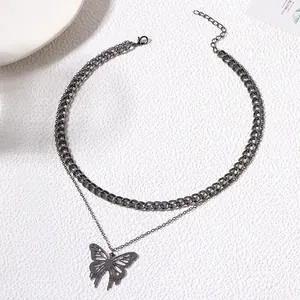 Detailed macro view of hollow butterfly pendant on double-layer alloy chain necklace