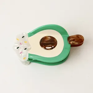 Close-up of a creative avocado ice cream shaped acetate hair claw clip for women.