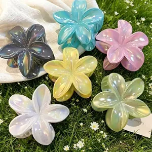 Assorted colorful pearlescent plumeria flower hair claw clips for beach vacations