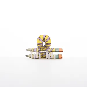 Close-up detail of a creative pencil-shaped hair claw clip with colorful wavy patterns