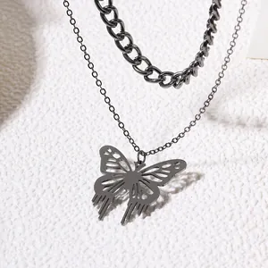 Detailed view of a stylish hollow butterfly pendant on a layered dark metal chain.