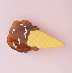 Close-up detail of a brown and yellow acetate ice cream cone shaped hair claw clip