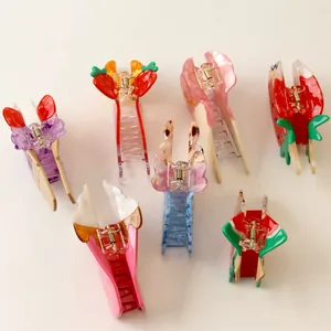 Close-up of colorful fruit and ice cream themed acetate shark hair clips in various styles