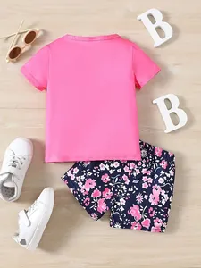 Toddler girl's summer outfit featuring a bright pink t-shirt and floral printed shorts
