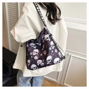 Detail view of large skull print tote bag worn by a model in casual home setting.