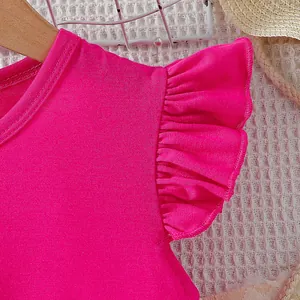 Close-up detail of a bright magenta ruffle sleeve cotton t-shirt for young girls.