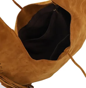 Interior view of brown suede fringe shoulder bag showing zipper pocket detail