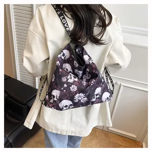 Detailed view of the large skull and floral print tote bag worn as a backpack on model