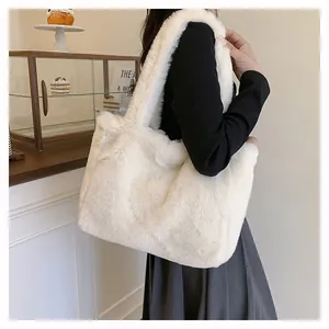 Large white faux fur tote bag shown on a model's shoulder for a cozy winter style.