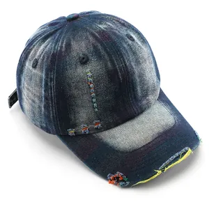 Vintage washed distressed denim baseball cap with frayed edges and colorful stitching details.