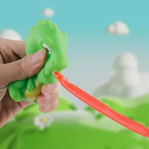 Jouet de dinosaure vert à presser avec langue rouge rétractable et sons amusants