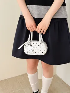 Trendy white bowling bag with black polka dots and decorative star charm for women