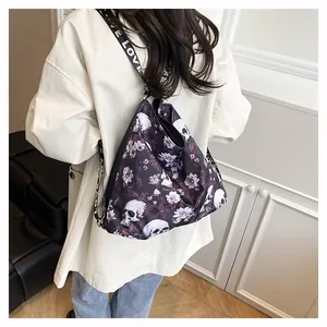 Large capacity versatile tote backpack with skull and floral print shown on a model