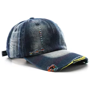 Distressed washed denim baseball cap with frayed details and ripped design for outdoors