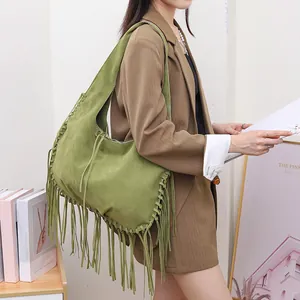 Stylish large green faux suede shoulder bag featuring long boho tassels and whipstitch detail