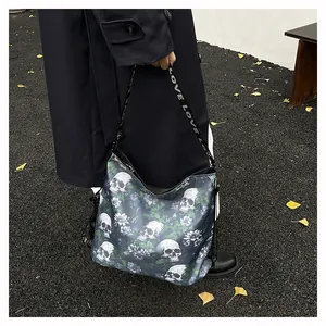 Detail shot of a trendy tote bag with skull and floral patterns in outdoor setting