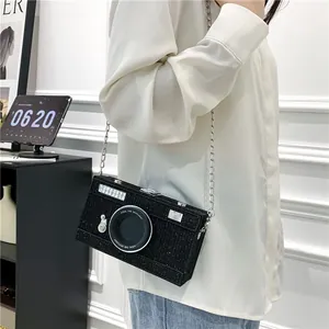 Trendy black camera-shaped box crossbody bag with silver chain strap for women's style