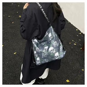 Large capacity crossbody tote bag with gothic skull and floral print on model